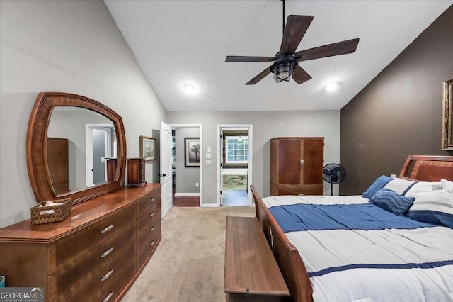 carpeted bedroom featuring vaulted ceiling, ceiling fan, and ensuite bathroom