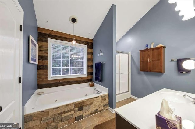 bathroom with vanity, vaulted ceiling, and separate shower and tub