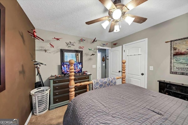 carpeted bedroom featuring a textured ceiling and ceiling fan