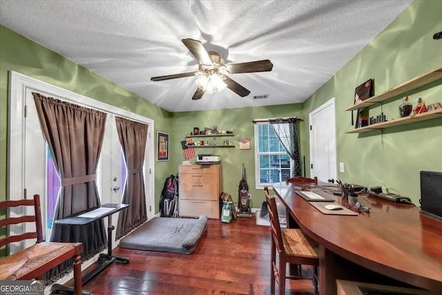 home office with ceiling fan, dark hardwood / wood-style floors, and a textured ceiling