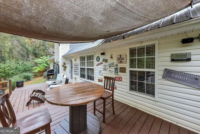 wooden deck with a grill