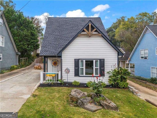 bungalow-style home with a front lawn