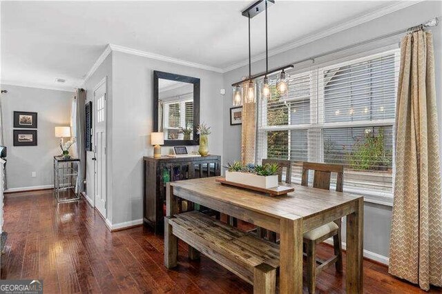 dining room with hardwood / wood-style floors, plenty of natural light, and ornamental molding