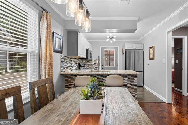 kitchen featuring white cabinetry, stainless steel appliances, sink, and tasteful backsplash