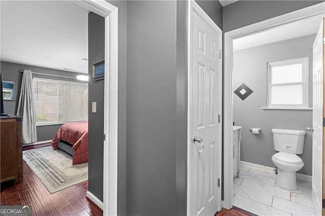 bathroom featuring toilet and hardwood / wood-style flooring