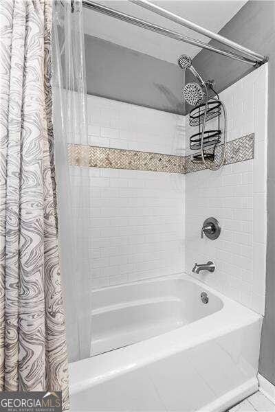 bathroom featuring shower / bath combination with curtain