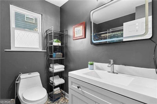 bathroom with toilet and vanity