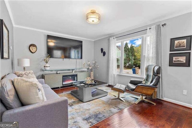 living room with crown molding and dark hardwood / wood-style flooring