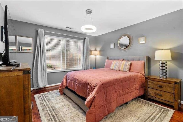 bedroom with hardwood / wood-style flooring