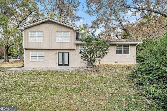 rear view of house with a yard