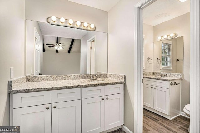 bathroom featuring hardwood / wood-style floors, ceiling fan, and vanity