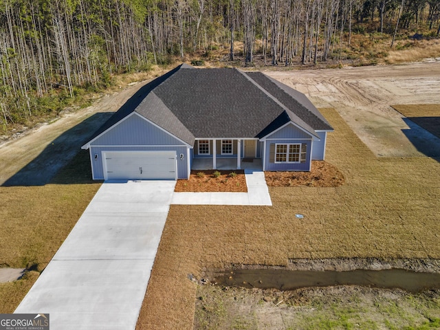 ranch-style home featuring a garage and covered porch