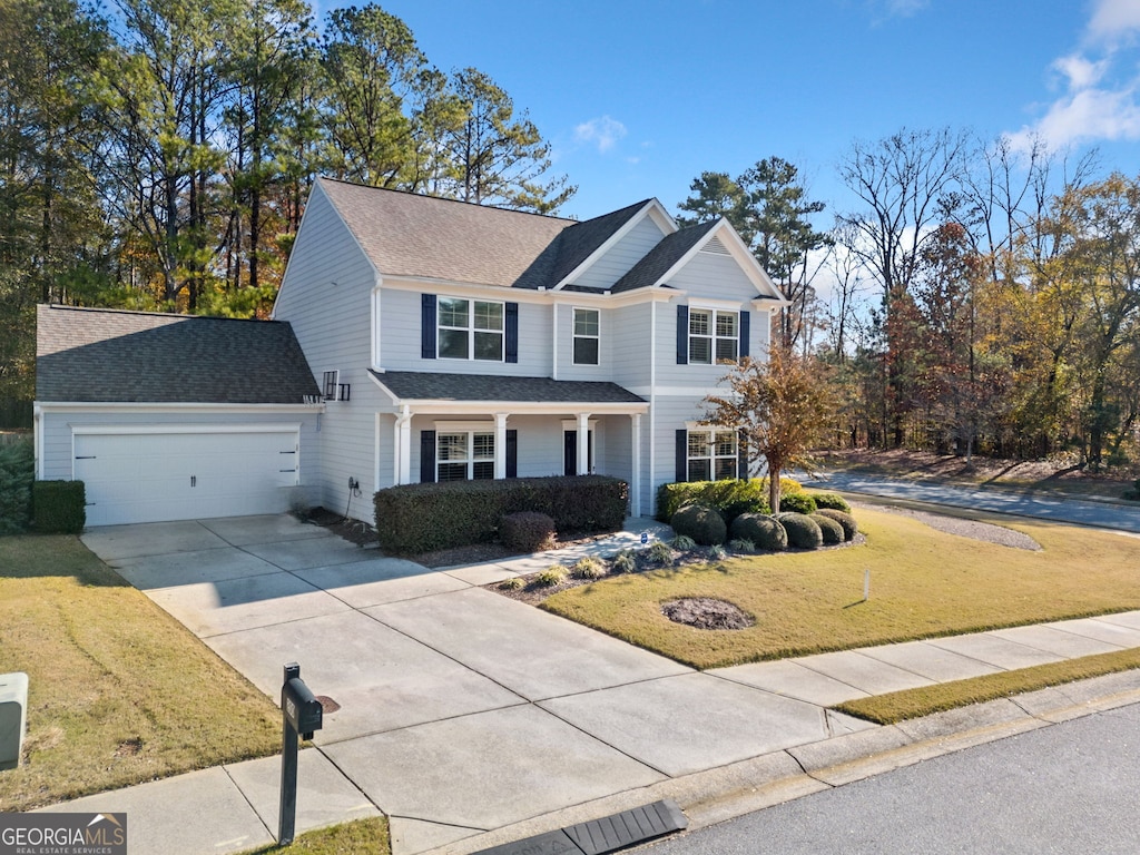 view of front facade with a garage and a front lawn