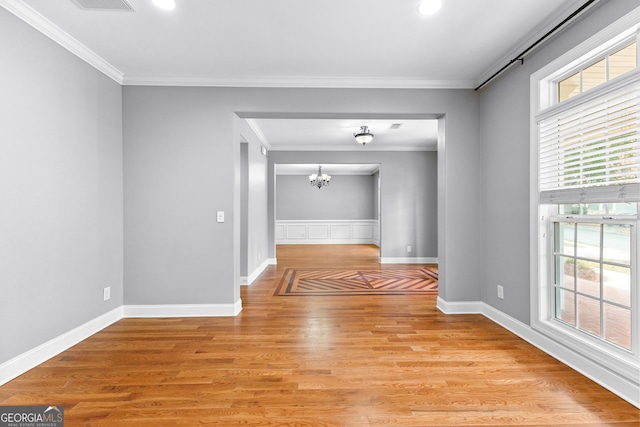 interior space featuring crown molding, a wealth of natural light, and light hardwood / wood-style flooring