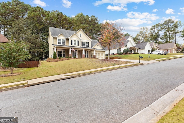 view of front property featuring covered porch and a front yard