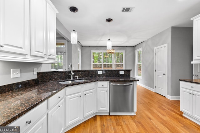 kitchen featuring white cabinets, pendant lighting, stainless steel dishwasher, and sink