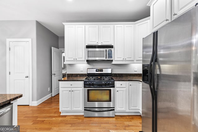 kitchen featuring white cabinetry, stainless steel appliances, and light hardwood / wood-style floors