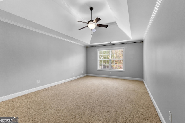 carpeted spare room featuring ceiling fan, crown molding, and a tray ceiling