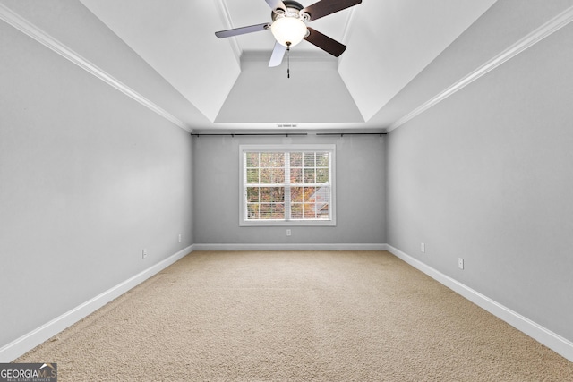 carpeted spare room featuring ceiling fan, lofted ceiling, and crown molding