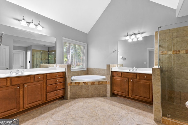 bathroom with tile patterned floors, vanity, separate shower and tub, and lofted ceiling