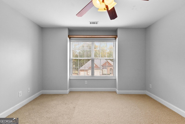 carpeted spare room with ceiling fan