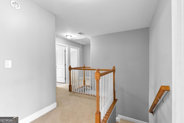 hallway featuring light carpet