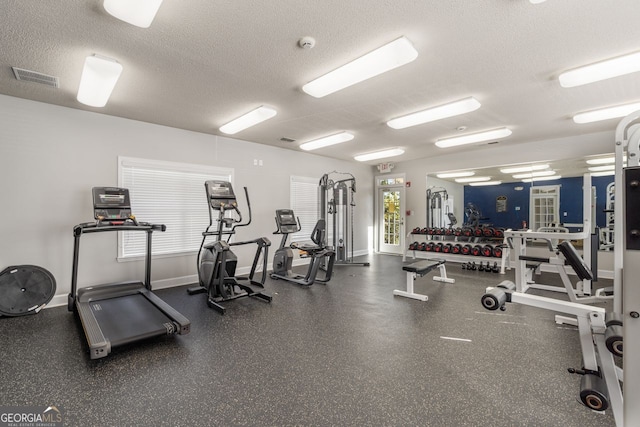 workout area featuring a textured ceiling