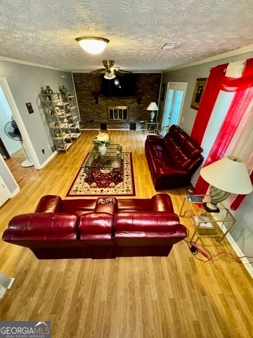 living room with ornamental molding, hardwood / wood-style floors, and a textured ceiling
