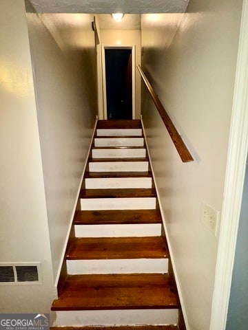stairway with wood-type flooring