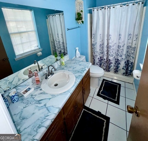 bathroom featuring toilet, a shower with curtain, vanity, and tile patterned flooring