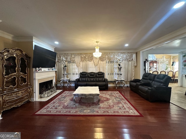 living area featuring ornamental molding, recessed lighting, a fireplace with flush hearth, and wood finished floors