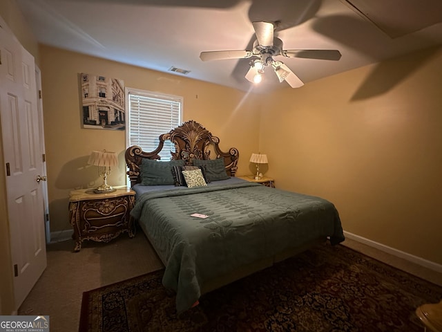 carpeted bedroom with a ceiling fan, visible vents, and baseboards