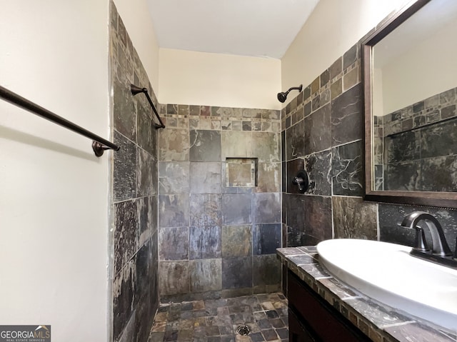 bathroom featuring sink and a tile shower