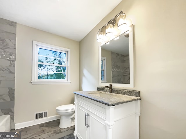 bathroom with toilet and vanity