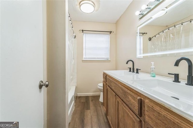 full bathroom featuring wood-type flooring, vanity, toilet, and shower / tub combo