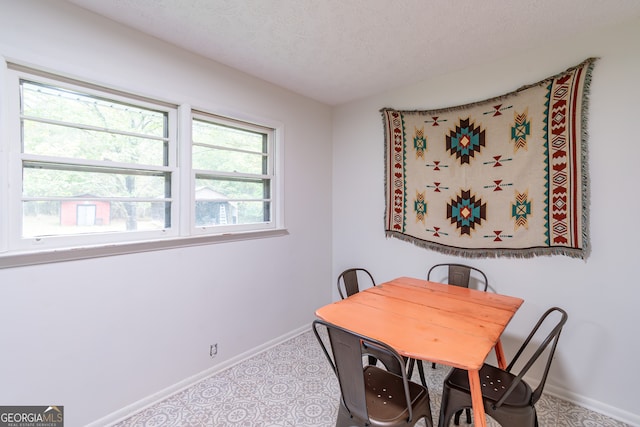 dining space featuring a textured ceiling