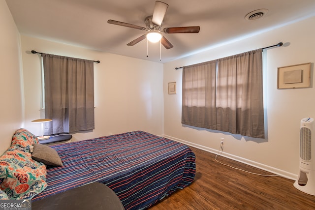 bedroom with ceiling fan and dark hardwood / wood-style floors