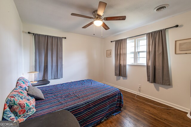 bedroom featuring ceiling fan and dark hardwood / wood-style floors