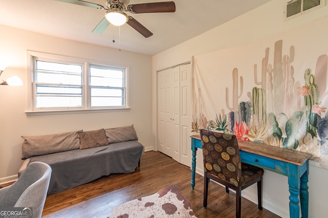 home office featuring dark wood-type flooring and ceiling fan