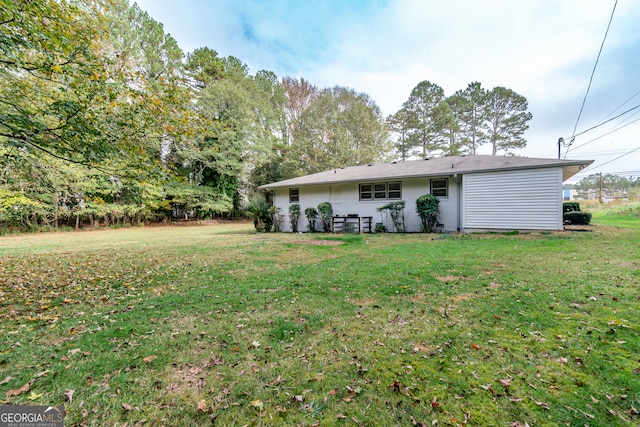 rear view of house featuring a yard