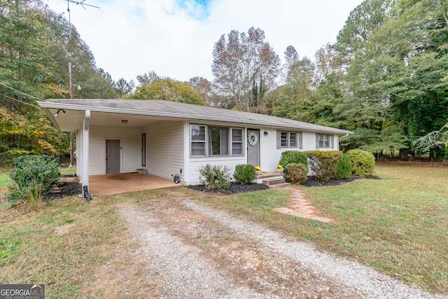 ranch-style home with a front lawn and a carport