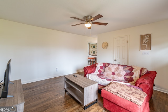 living room featuring dark hardwood / wood-style flooring and ceiling fan