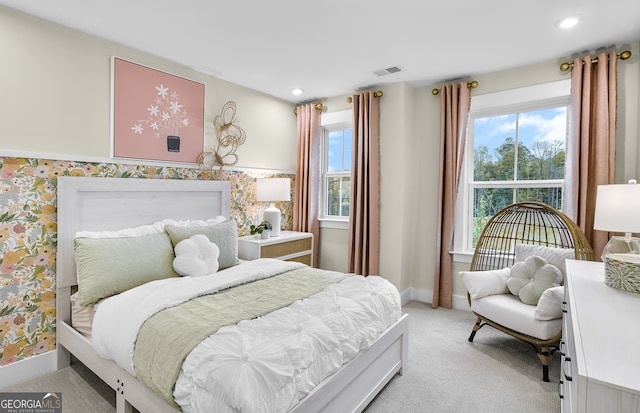 bedroom featuring multiple windows and light colored carpet