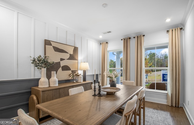 dining area featuring dark hardwood / wood-style floors and crown molding