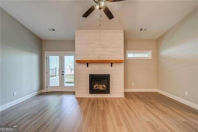 unfurnished living room with ceiling fan, french doors, and wood-type flooring