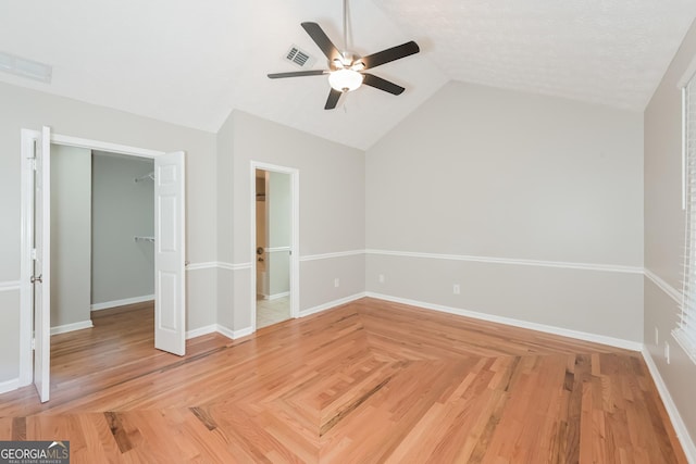 interior space featuring a textured ceiling, ceiling fan, vaulted ceiling, and hardwood / wood-style flooring