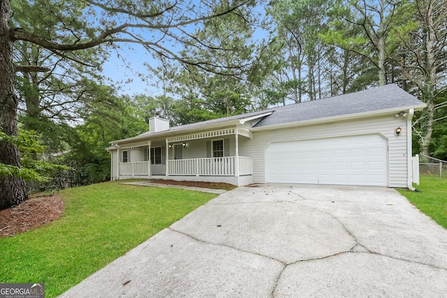 single story home featuring covered porch, a garage, and a front yard