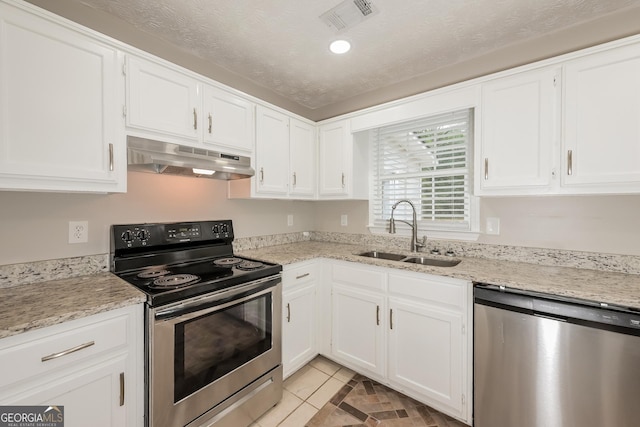 kitchen with white cabinets, appliances with stainless steel finishes, a textured ceiling, and sink