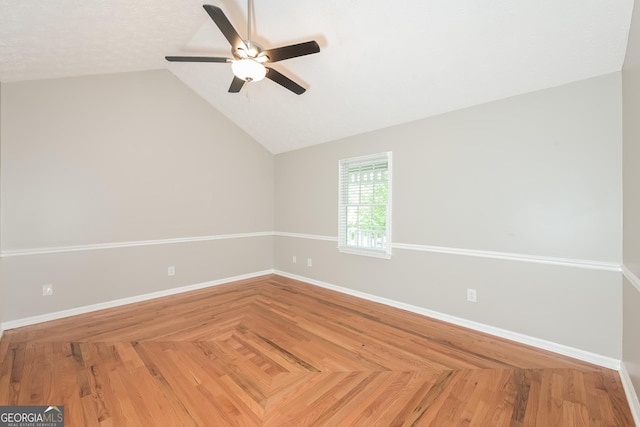 empty room featuring a textured ceiling, vaulted ceiling, and ceiling fan