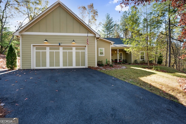 view of front of property featuring a garage and a front lawn